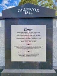 A detailed view of the curved, rustic stone retaining wall at Camberwell Sports Ground, topped with smooth, custom coping stones supplied by Eigen Stones.