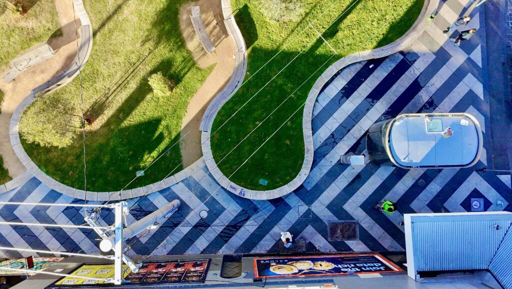 A top-down aerial view of Otto St parklet in Collingwood, showcasing the bold black-and-white striped stone paving and curved stone garden edging supplied by Eigen Stones.