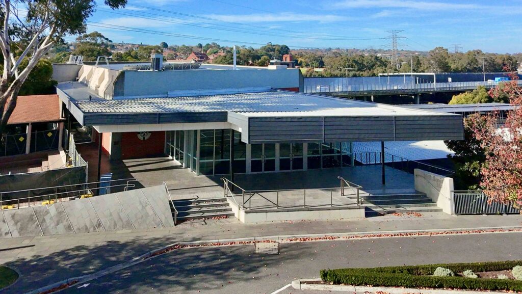 An aerial view of a modern building at St Kevin's, highlighting the clean lines of the stone-paved plaza and staircases supplied by Eigen Stones.