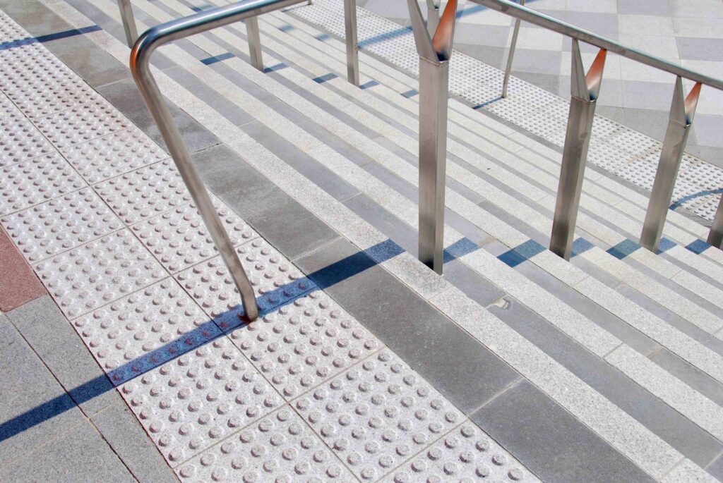The vibrant orange entrance to the Melbourne Convention Centre, complemented by a patterned stone forecourt with pavers supplied by Eigen Stones.