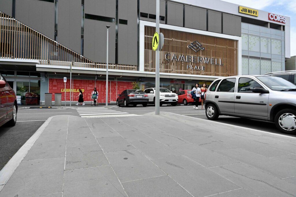 The modern entrance to The Well at Camberwell Place, showing the clean stone-paved footpath and pedestrian crossing with materials supplied by Eigen Stones.