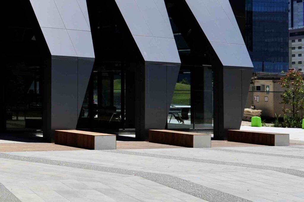 The "St Mary of the Cross Square" metal sign set into the patterned stone paving of the ACU campus, with all stone supplied by Eigen Stones.