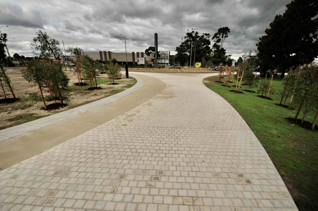  The striking, angular facade of a modern building at Monash University, fronted by an expansive, minimalist stone plaza from Eigen Stones.